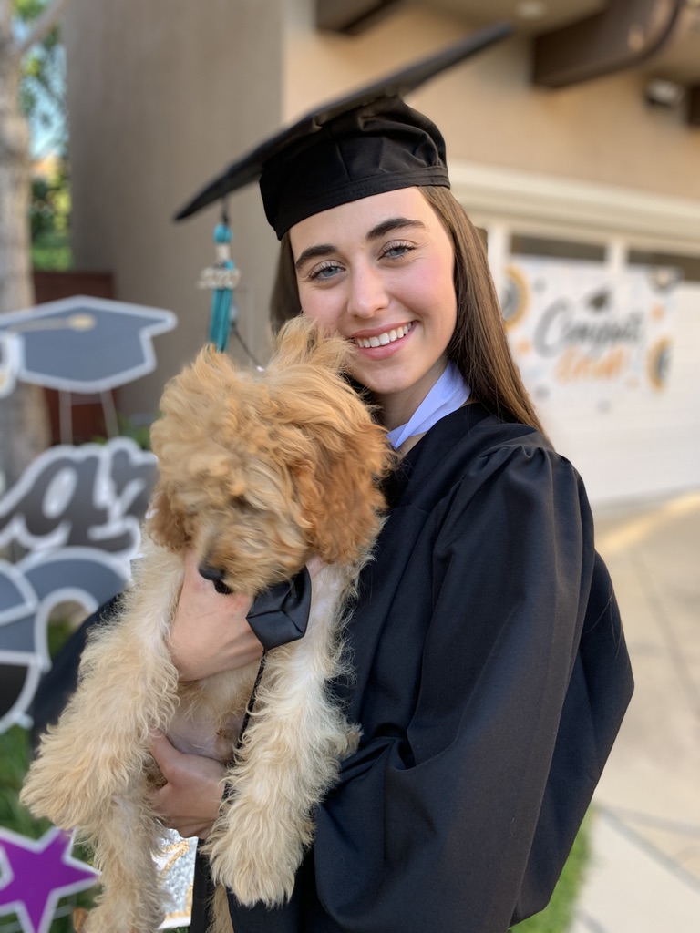 Girl Celebrating Graduation Day with Her Dog